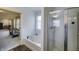 Bathroom with a bathtub and separate shower, adjacent to an area with access to other rooms at 1583 Valdarno Dr, Greenwood, IN 46143