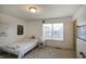 Bright bedroom with a twin bed, geometric patterned rug, and large window at 1583 Valdarno Dr, Greenwood, IN 46143