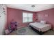 Pink themed bedroom with window view, including a round rug and playhouse at 1583 Valdarno Dr, Greenwood, IN 46143