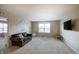 A bonus room with carpet, a couch, and a flat screen tv at 1583 Valdarno Dr, Greenwood, IN 46143