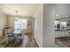 Bright dining area with wood floors, natural light, and view to kitchen at 1583 Valdarno Dr, Greenwood, IN 46143
