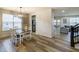 Open dining room with wood flooring, a chandelier, and a view of the living area at 1583 Valdarno Dr, Greenwood, IN 46143
