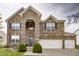 Charming two-story brick home with a three-car garage and well-maintained landscaping at 1583 Valdarno Dr, Greenwood, IN 46143