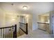 Upstairs hallway with carpet and iron railings at 1583 Valdarno Dr, Greenwood, IN 46143