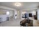 Spacious living room with a large desk, comfortable seating, and seamless transitions to connected rooms at 1583 Valdarno Dr, Greenwood, IN 46143