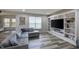 Open living room with a gray couch, built-in shelving, and lots of natural light at 1583 Valdarno Dr, Greenwood, IN 46143