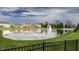 Scenic view of a community pond with a fountain, surrounded by well-maintained lawns at 1583 Valdarno Dr, Greenwood, IN 46143