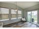 Bright sunroom with three windows, sliding glass door, and modern light fixture at 1583 Valdarno Dr, Greenwood, IN 46143