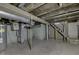 Unfinished basement with concrete floor and stairs at 1623 N Centennial St, Indianapolis, IN 46222