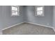 A cozy bedroom is illuminated by natural light streaming in from two windows at 1623 N Centennial St, Indianapolis, IN 46222