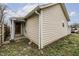 Shows the exterior of the home with beige siding and a small window at 1623 N Centennial St, Indianapolis, IN 46222
