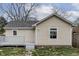 Beige home with gray shingles, a small deck, and vinyl siding stands ready for its new owner at 1623 N Centennial St, Indianapolis, IN 46222