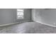 Sunlight streams in through the window of this inviting living room with gray walls at 1623 N Centennial St, Indianapolis, IN 46222