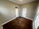 This bedroom features hardwood floors, neutral walls, and two closets with arched doorways at 1626 S State Ave, Indianapolis, IN 46203