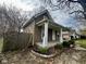 Side view of a home with a charming porch and wooden fence in a quiet neighborhood at 1626 S State Ave, Indianapolis, IN 46203