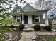 Inviting home featuring a cozy front porch with classic white pillars and neutral siding at 1626 S State Ave, Indianapolis, IN 46203