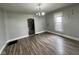 Spacious living room features refinished hardwood floors, fresh paint, and great natural light at 1626 S State Ave, Indianapolis, IN 46203