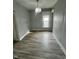 Empty room featuring hardwood floors, fresh paint, one window and ample sunlight at 1626 S State Ave, Indianapolis, IN 46203