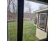 View from inside of backyard with lawn, lake, dock, and house in distance at 1647 S Plateau Cir, Martinsville, IN 46151