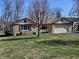 Charming ranch-style home with a stone facade, two-car garage, and a tree in front at 1647 S Plateau Cir, Martinsville, IN 46151
