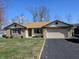 Charming ranch-style home with a stone facade, two-car garage, and well-maintained lawn at 1647 S Plateau Cir, Martinsville, IN 46151
