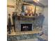 Stone fireplace featuring a wooden mantle and hearth, creating a cozy and inviting focal point in the living area at 1647 S Plateau Cir, Martinsville, IN 46151