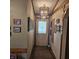 Hallway features decorative light fixture, cream colored walls, and wood trim at 1647 S Plateau Cir, Martinsville, IN 46151