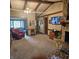 Spacious living room with stone fireplace, wood beams, and a cozy red chair at 1647 S Plateau Cir, Martinsville, IN 46151