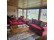 Comfortable living room with large windows, wood paneled ceiling, bright sofas, and natural light providing a relaxing atmosphere at 1647 S Plateau Cir, Martinsville, IN 46151