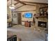 Spacious living room featuring a stone fireplace, exposed beams, and a TV perfect for entertaining at 1647 S Plateau Cir, Martinsville, IN 46151
