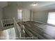 A view of a bright and airy bedroom with wood-look flooring, a ceiling light, and neutral wall paint at 1708 W 7Th St, Muncie, IN 47302