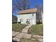 Inviting two-story home with a well-maintained lawn and traditional architectural details at 1708 W 7Th St, Muncie, IN 47302