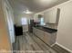 Well-lit kitchen featuring stainless steel appliances, sleek gray cabinetry, and modern countertops at 1708 W 7Th St, Muncie, IN 47302