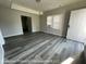 A view of a spacious living room with hardwood floors and lots of natural light at 1708 W 7Th St, Muncie, IN 47302