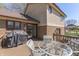 Outdoor deck with a glass table and chairs, a nearby grill, and a view of the backyard at 1772 Woodridge Pl, Greenwood, IN 46143