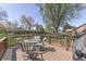Back deck featuring a glass-top table with chairs, surrounded by trees at 1772 Woodridge Pl, Greenwood, IN 46143