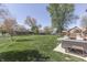 Extensive backyard with a large lawn, mature trees, patio seating and an expansive view at 1772 Woodridge Pl, Greenwood, IN 46143