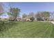 Expansive backyard with lush green lawn, mature trees, and neighboring houses at 1772 Woodridge Pl, Greenwood, IN 46143