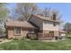 Large backyard featuring a brick exterior, wooden deck, and patio with outdoor seating at 1772 Woodridge Pl, Greenwood, IN 46143