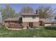 Spacious backyard with brick accents, a wooden deck, and patio with outdoor seating at 1772 Woodridge Pl, Greenwood, IN 46143