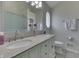 Bathroom includes double sink vanity with granite countertops, patterned wall, and a glass door shower at 1772 Woodridge Pl, Greenwood, IN 46143