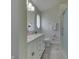 Bathroom featuring a double sink vanity with granite countertops, patterned wall, and a glass door shower at 1772 Woodridge Pl, Greenwood, IN 46143