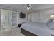 Bedroom featuring a ceiling fan, sliding glass door to bathroom, and white closets for storage at 1772 Woodridge Pl, Greenwood, IN 46143
