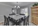 Well-lit dining room features modern light fixture, large square table, and adjacent room views at 1772 Woodridge Pl, Greenwood, IN 46143