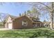 Side view of a well-maintained house featuring a garage and a manicured lawn at 1772 Woodridge Pl, Greenwood, IN 46143