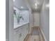 Hallway featuring wood flooring, white wainscoting, and a decorative floral arrangement at 1772 Woodridge Pl, Greenwood, IN 46143