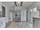 Updated kitchen features stainless steel refrigerator, white cabinetry, and open design at 1772 Woodridge Pl, Greenwood, IN 46143