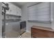 Laundry room featuring modern appliances and storage cabinets at 1772 Woodridge Pl, Greenwood, IN 46143