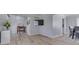 Open-concept living room with wood floors, TV, and adjacent dining area at 1772 Woodridge Pl, Greenwood, IN 46143