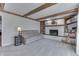 Spacious living room featuring a brick fireplace, comfortable seating, and exposed wood beams at 1772 Woodridge Pl, Greenwood, IN 46143